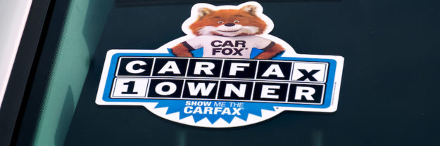 A Carfax History Report logo on a car.